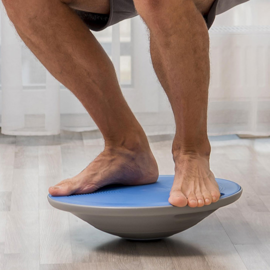 Close up of person's legs on a balance board